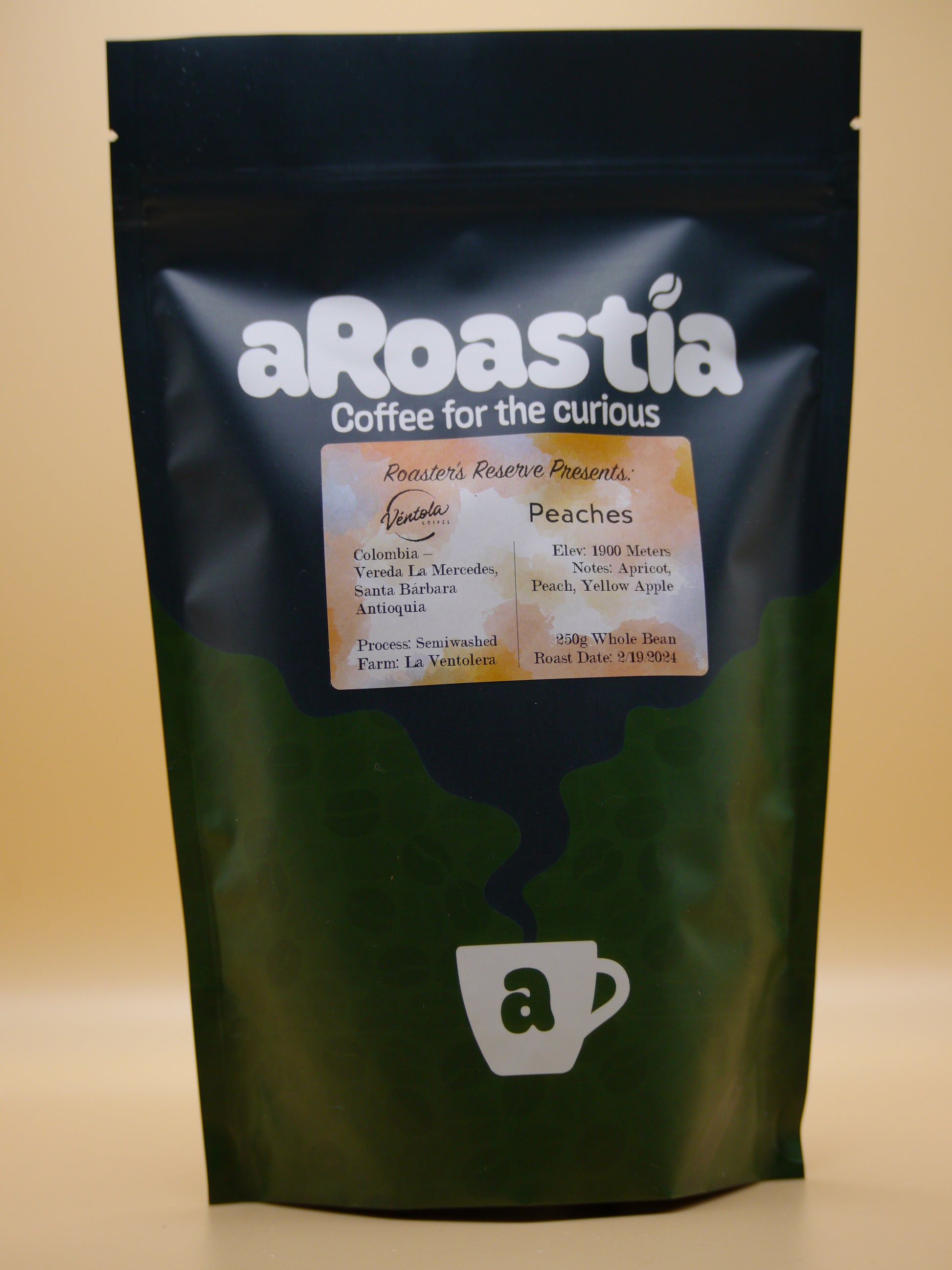 A photo of a bag of Peaches, a washed processed coffee offered by aRoastia. The bag has an orange colored label on it, with information about the coffee. The coffee beans were picked at an elevation of 1900 meters above sea level, and went through a semiwashed process.
